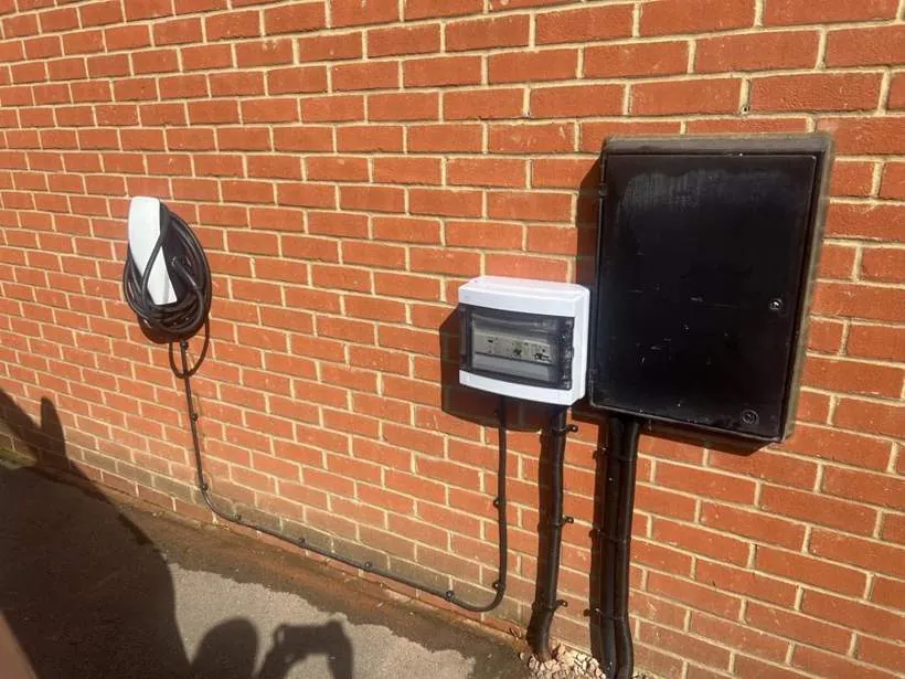 Tesla Wall Connector with a separate external enclosure housing PME fault protection, beside the meter box, Buckingham