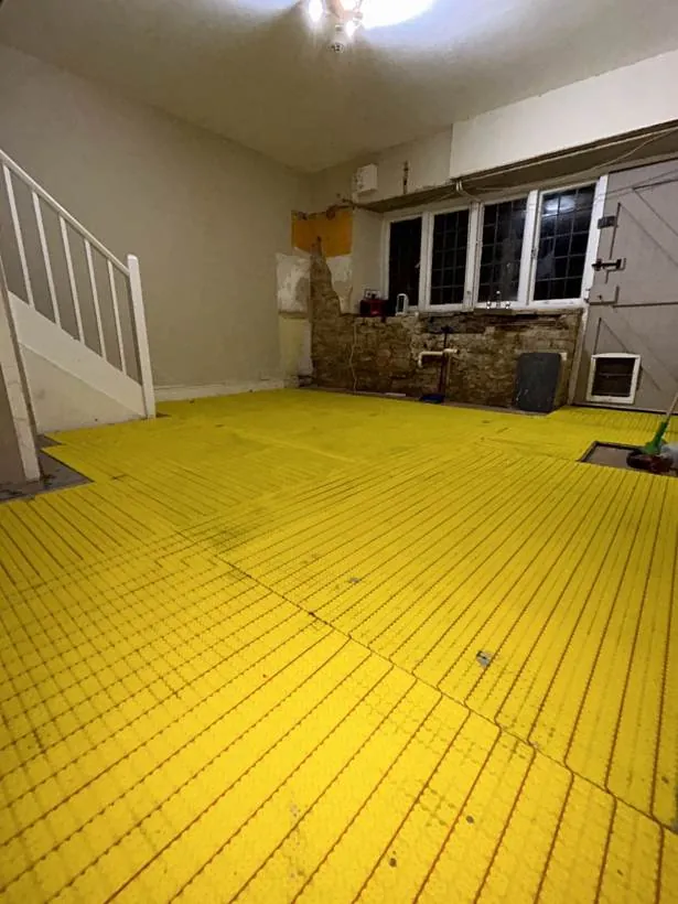 Electric underfloor heating laid across a kitchen floor ready for tiling, North Aston, Oxfordshire