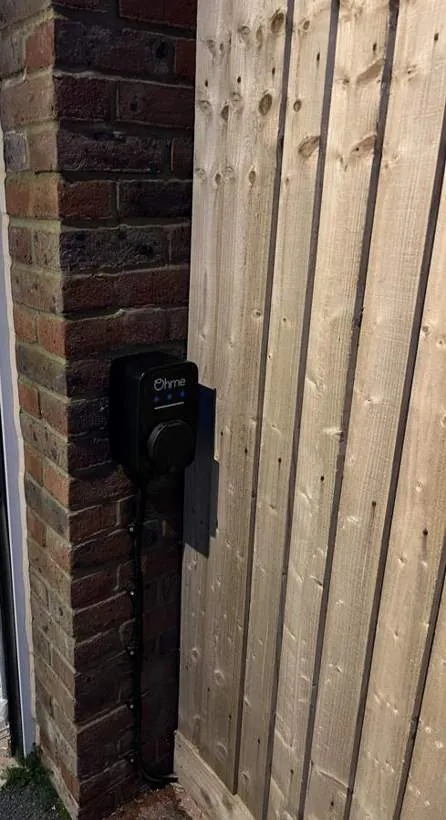Ohme EV charger mounted on a brick pier beside a timber gate, Heyford near Bicester