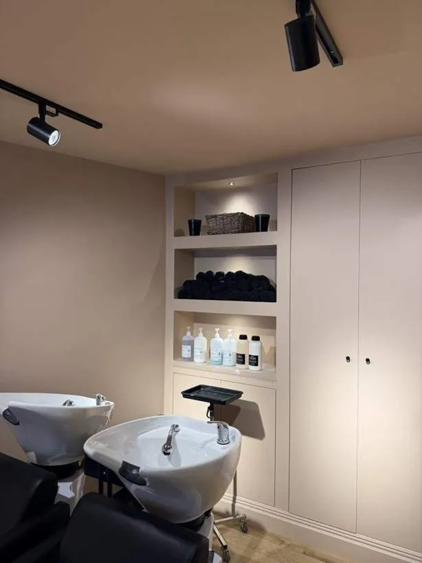 Built-in salon shelving with recessed LED spotlights beside track lighting, Lechlade, Cotswolds