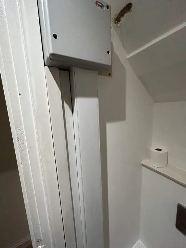 Steel adaptable box housing DIN rail terminals where circuits were extended from the old consumer unit position, with trunking down to the new location, Summertown, Oxford