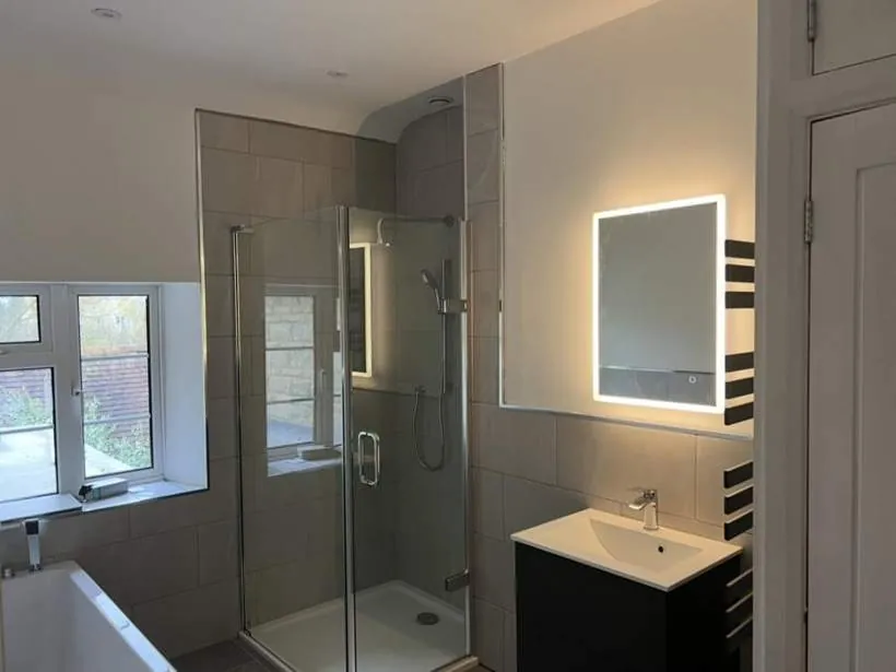 Modern bathroom with an illuminated LED mirror, downlights and extractor fan, Marsh Gibbon near Bicester