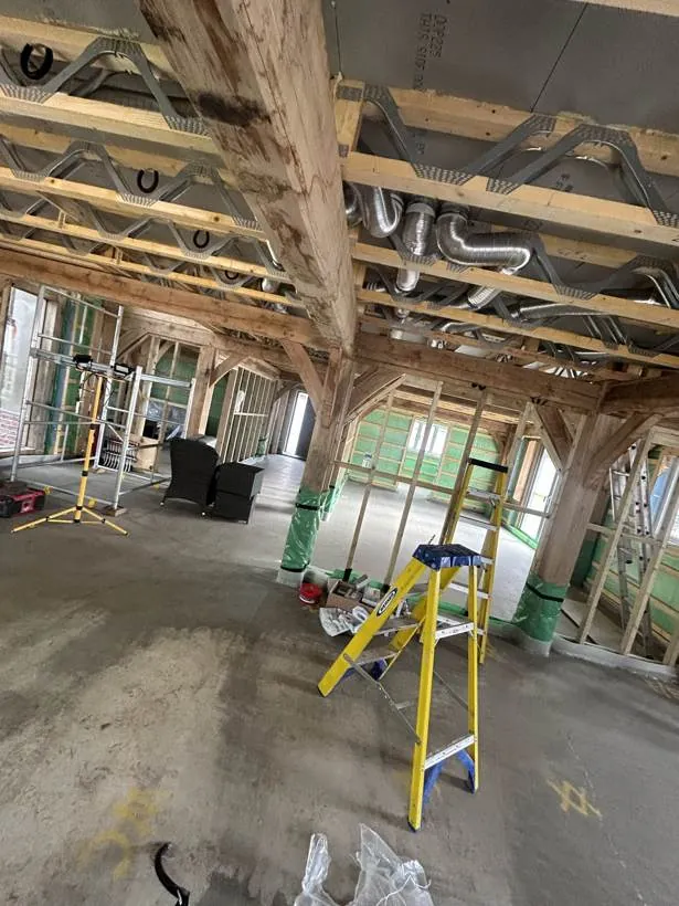 Oak frame interior during first fix, with services running through the open ceiling, village near Bicester