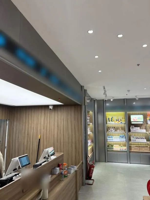 Completed till area with lighting and power, alongside lit shelving in a retail store in Oxford