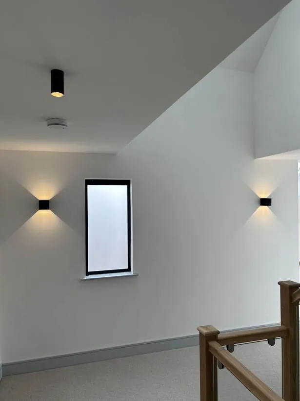 Landing with up and down wall lights and black spotlights, new build home at Graven Hill, Bicester
