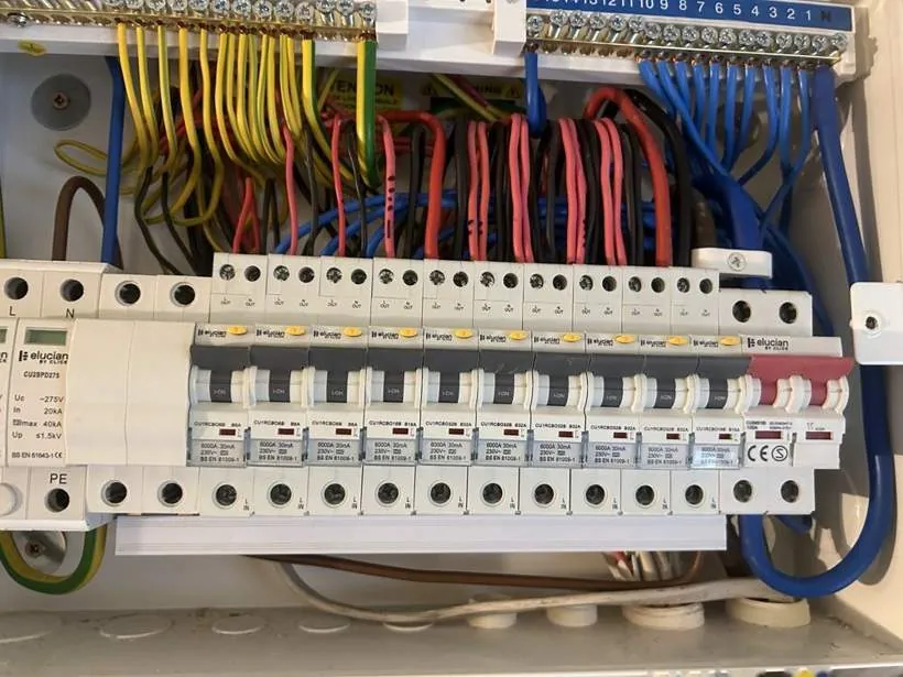 New consumer unit with individual RCBO protection on every circuit and a surge protection device, neatly dressed wiring, Buckinghamshire