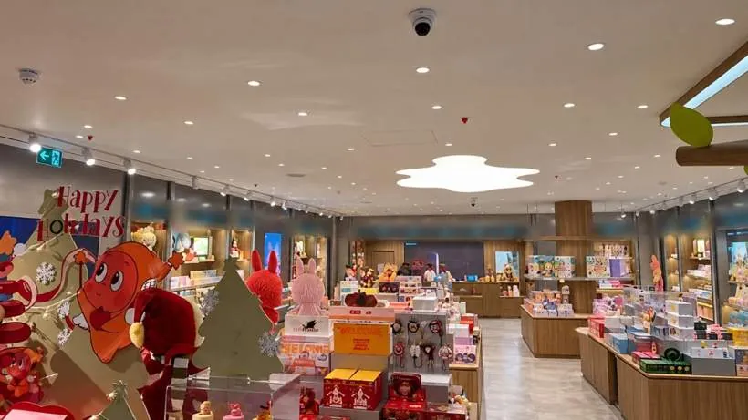 Completed retail shop floor with recessed downlights, track spotlights and lit display shelving throughout, Oxford