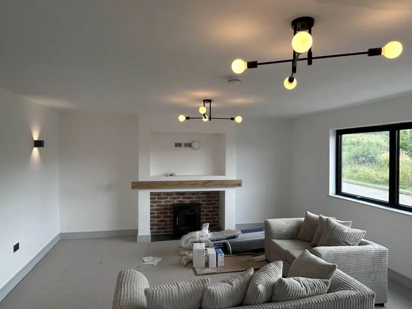 Living room with feature ceiling lights and wall lights, new build home at Graven Hill, Bicester