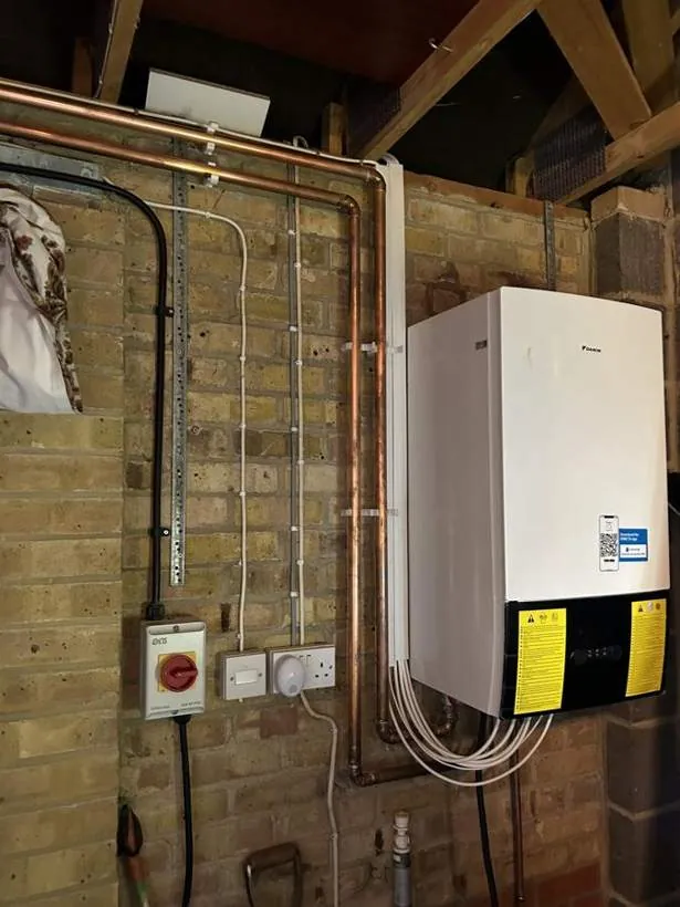Daikin heat pump indoor unit on a garage wall with isolator, new supply and control wiring, Buckinghamshire