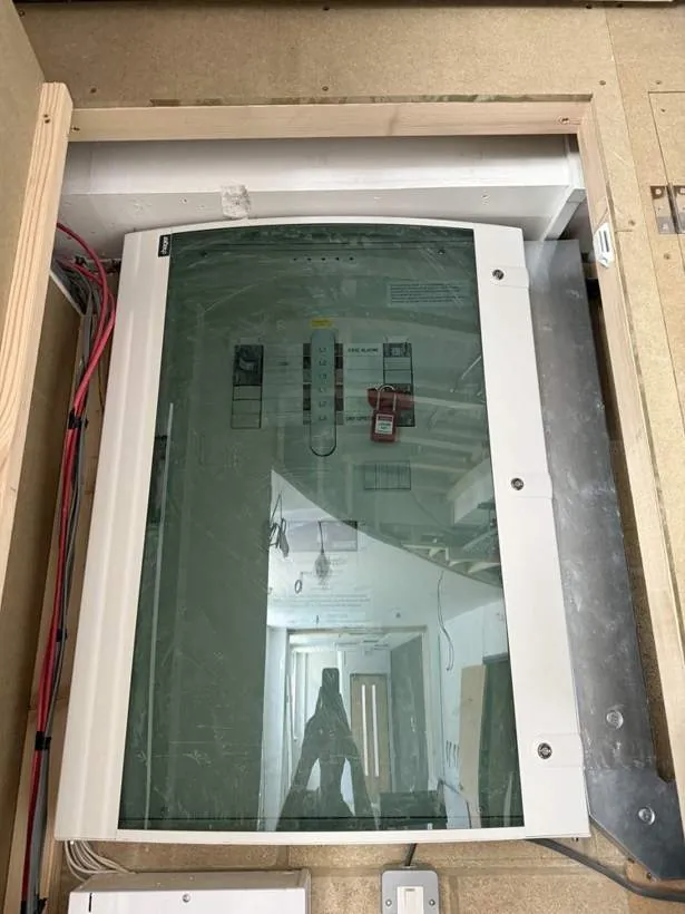 New glass-fronted distribution board fitted within a timber surround after an EICR, Bicester