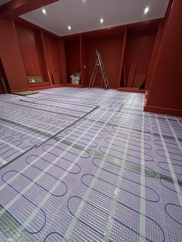 Electric underfloor heating mats laid across a large room ready for the floor finish, Banbury