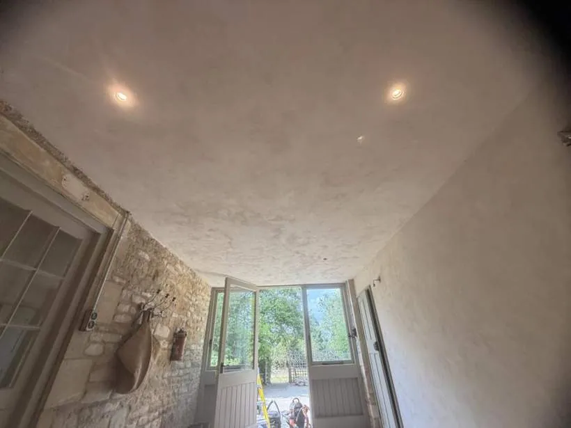 Recessed downlights in a light ceiling above a stone-walled room leading to the garden, Charlbury