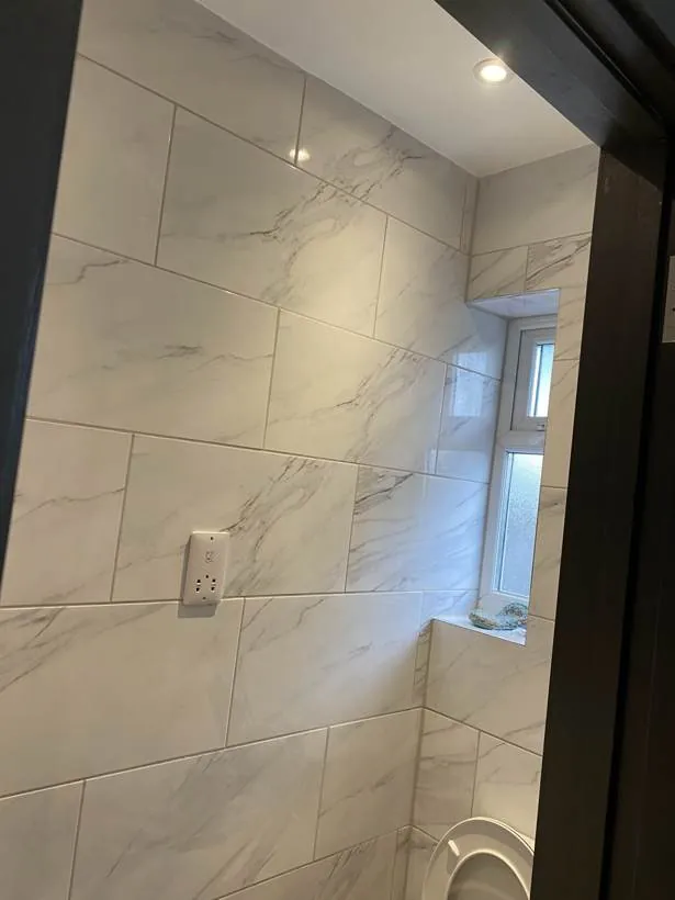 Tiled HMO en-suite with a recessed downlight and wall-mounted shaver socket, Feltham