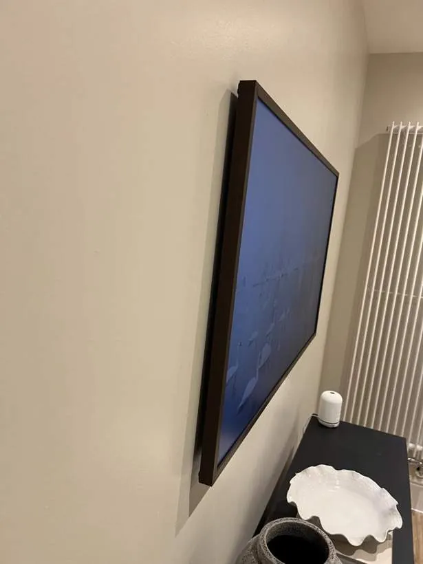 Side view of a Samsung The Frame TV mounted flush against the wall with no visible cabling