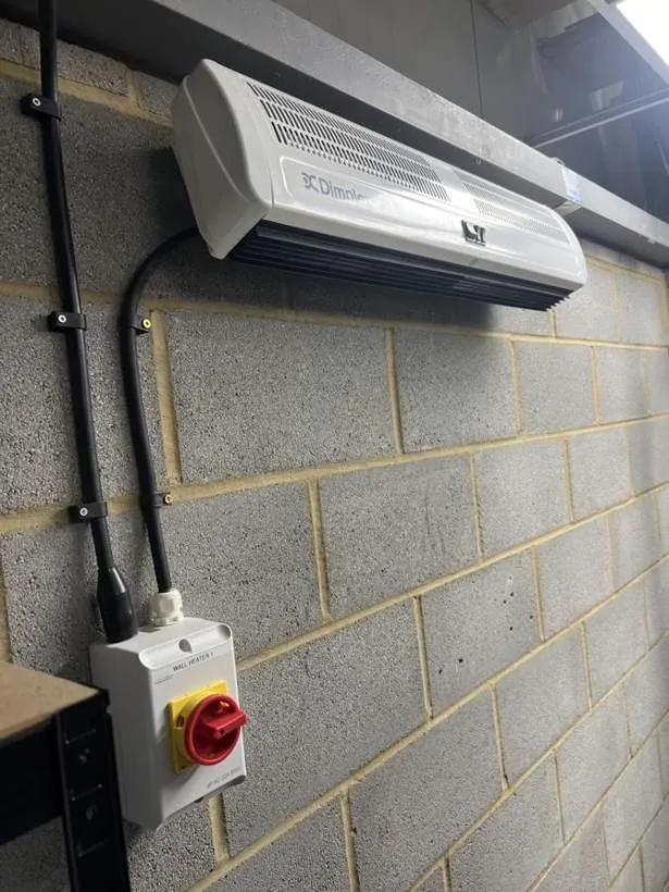 High-output wall-mounted heater with a dedicated supply and rotary isolator in a commercial unit, Oxford