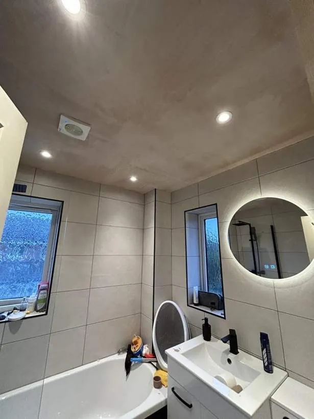 Bathroom with recessed downlights, a round illuminated mirror and a ceiling extractor fan, Bicester
