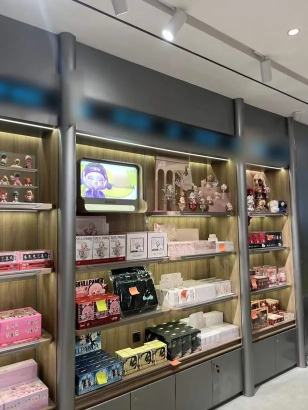 Retail display shelving with integrated lighting and small screens, completed shop fit-out in Oxford