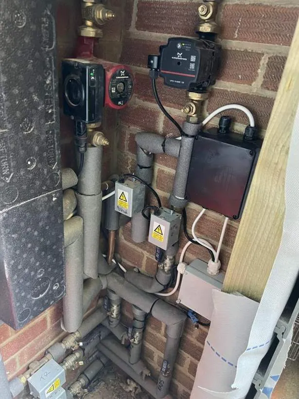 Neatly wired heating system with pump, zone wiring centre and isolators beside the pipework, Adderbury
