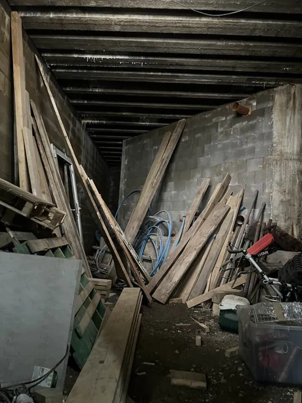 the derelict basement, full of timber and debris, basement conversion in Chinnor