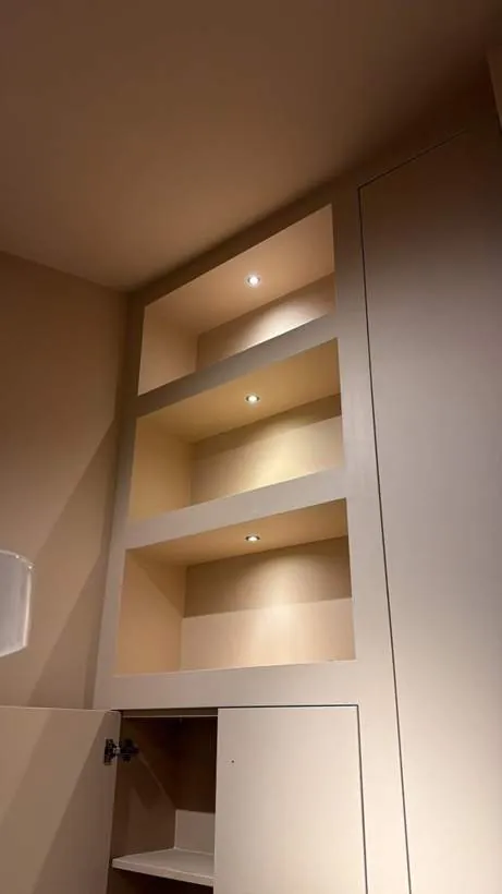 Three recessed LED spotlights lighting built-in alcove shelving in a hair salon, Lechlade