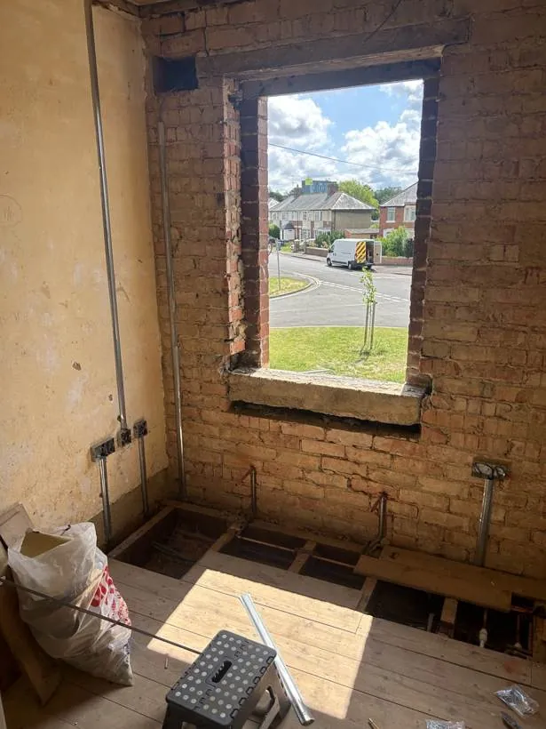 Room stripped back to brick with neat first fix cable drops and back boxes, part of a full rewire in Oxford