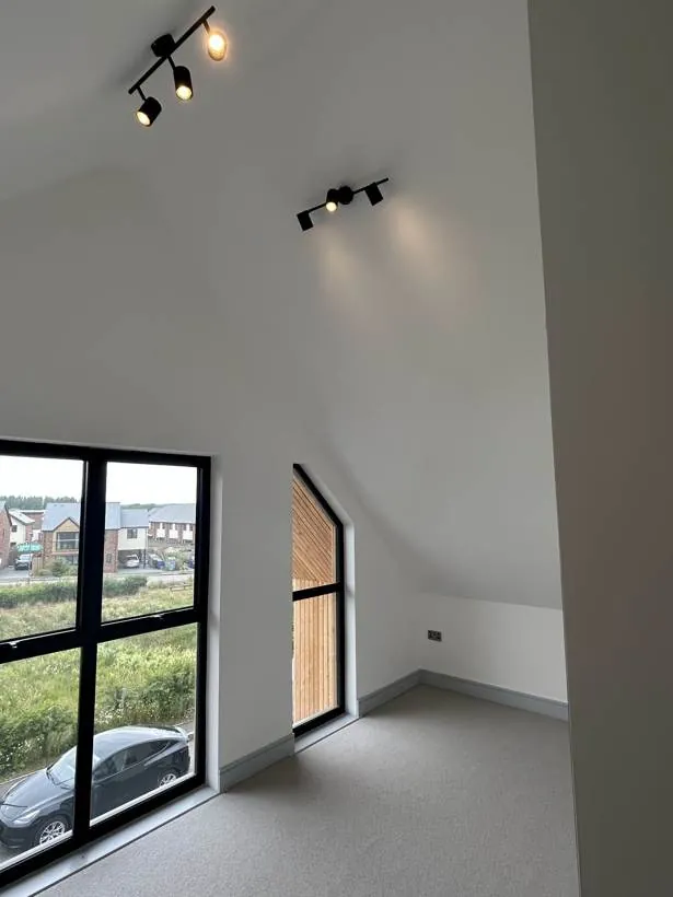 Vaulted room with black track spotlights, new build home at Graven Hill, Bicester