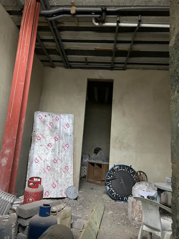bare walls and exposed services ahead of the conversion, basement conversion in Chinnor