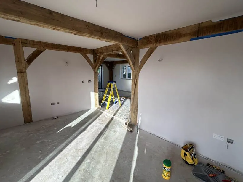 Plastered oak frame living space with new sockets during second fix, village near Bicester