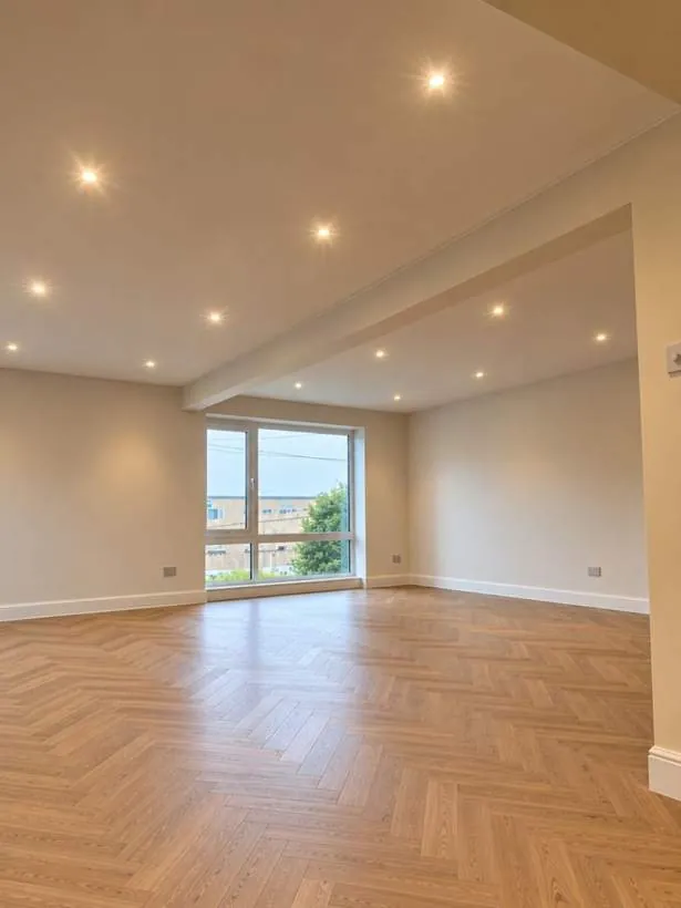 Evenly spaced LED downlights across the ceiling of a large open-plan room with herringbone flooring and new sockets in Wantage, Oxfordshire