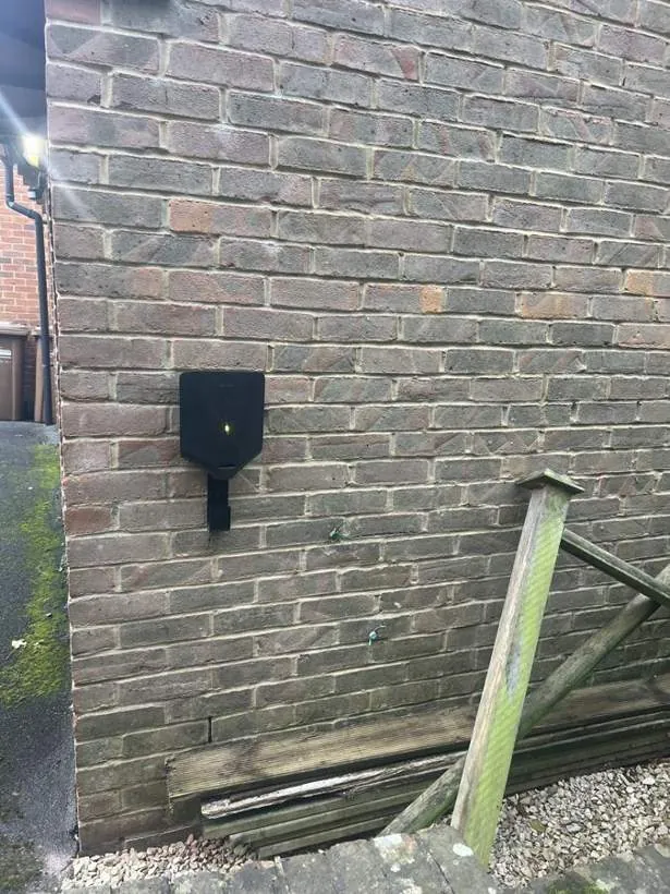 Easee EV charger neatly fitted on a brick side wall after a complex cable run, Thame, Oxfordshire