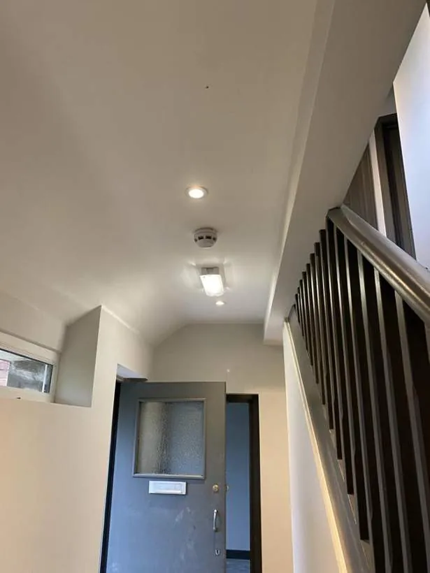 HMO hallway and stairs with new downlights, emergency lighting and addressable fire alarm devices, Feltham