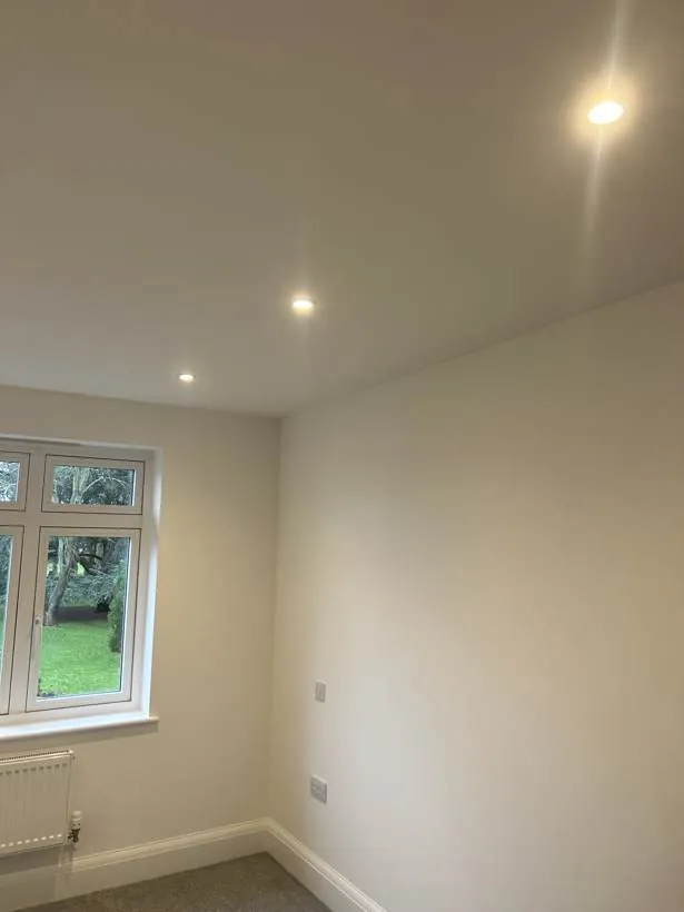 Freshly finished bedroom with recessed downlights, light switch and double socket, part of a full rewire in Oxford