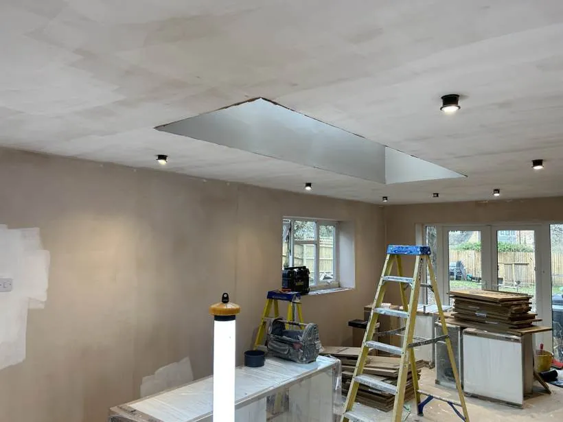 Freshly plastered extension ceiling with new downlights switched on around the roof lantern opening, Brackley