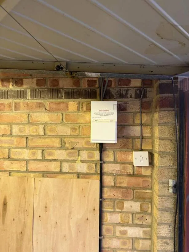 New consumer unit and socket on a brick garage wall, Bicester