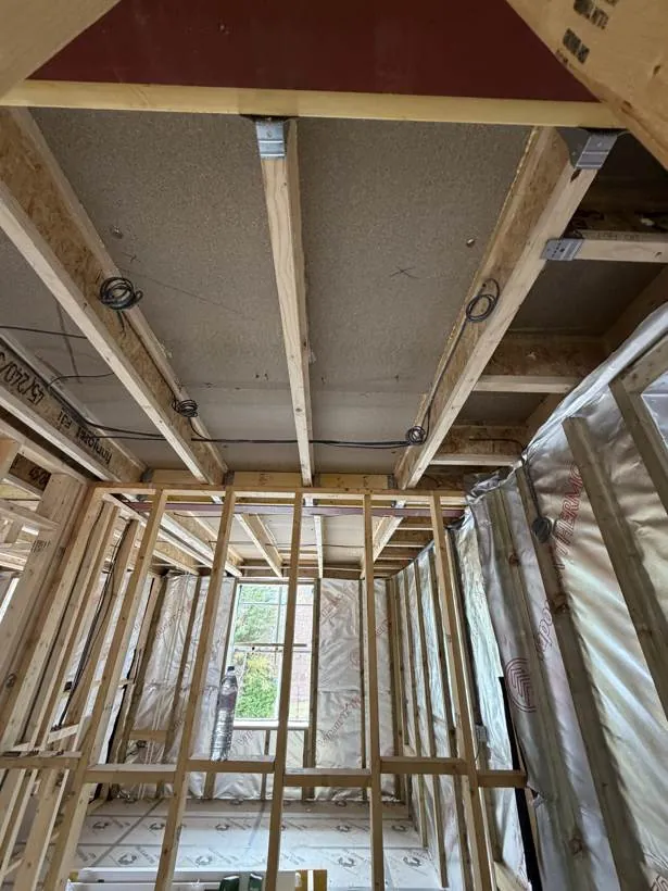 Timber frame new build interior with first fix cables coiled ready at each light position, Fleet