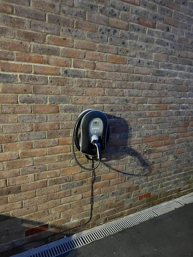myenergi zappi EV charger on a brick wall beside a driveway, Heyford near Bicester