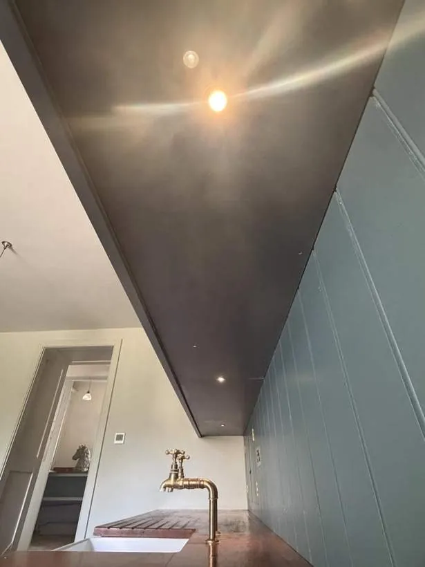Antique brass recessed spotlights set into the underside of a kitchen cabinet, Woodstock, Oxfordshire