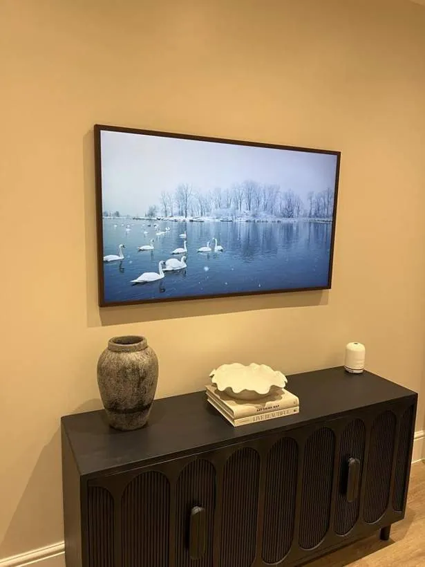 Samsung The Frame TV hung like a picture above a sideboard, with no visible cables or sockets