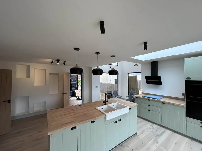 Kitchen island with pendants and black spotlights, new build home at Graven Hill, Bicester